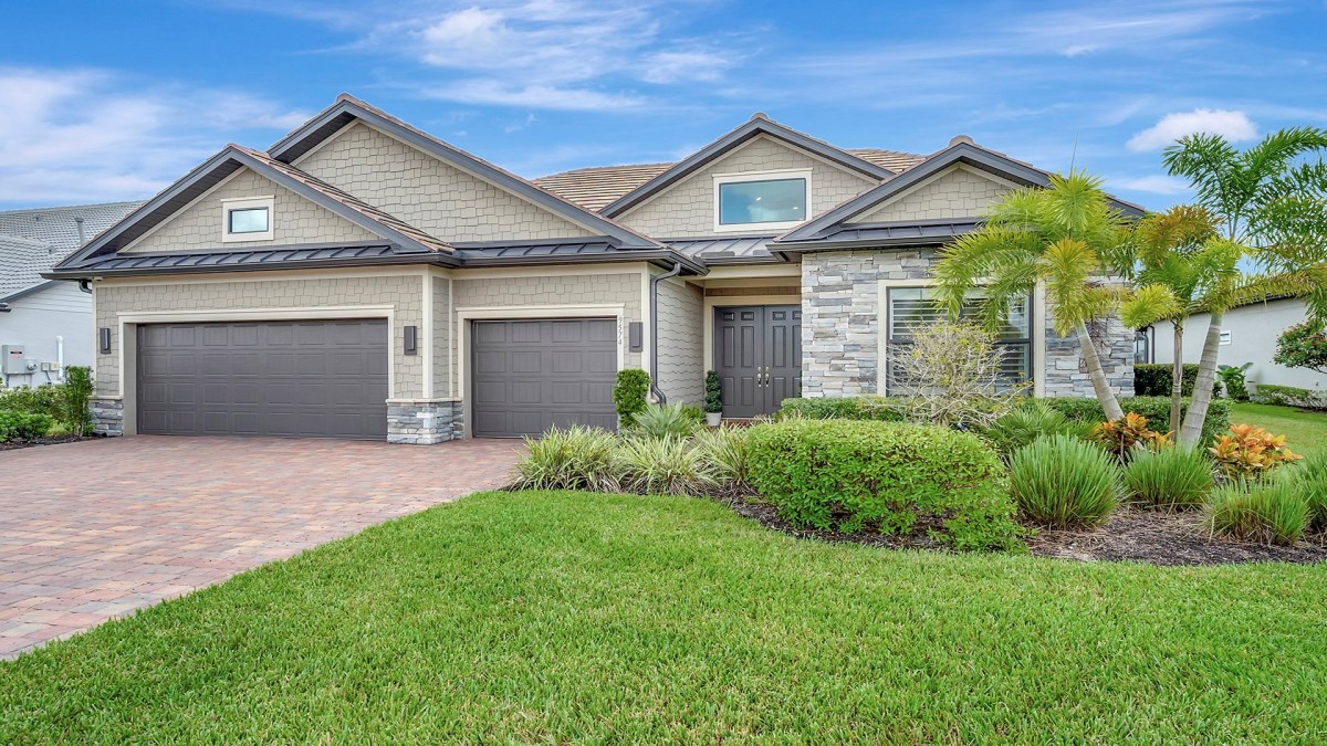 Exterior with Large Driveway and 3 Car Garage