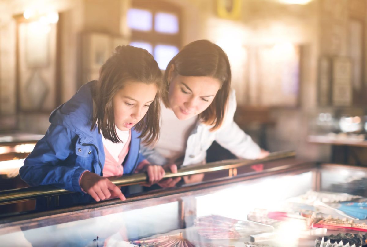 mother and daughter looking into a display case